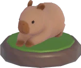 Adorno capibara tumbado boca abajo
